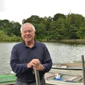Tom Lambert on the pontoon at Linlithgow Loch with Linlithgow Palace in the trees behind him. Picture by Nigel Duncan