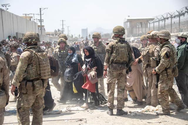 British and American troops help in the evacuation of eligible civilians and their families out of Afghanistan