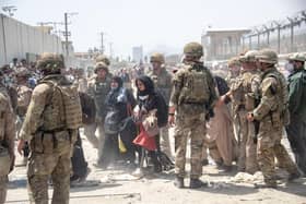 British and American troops  help in the evacuation of eligible civilians and their families out of Afghanistan