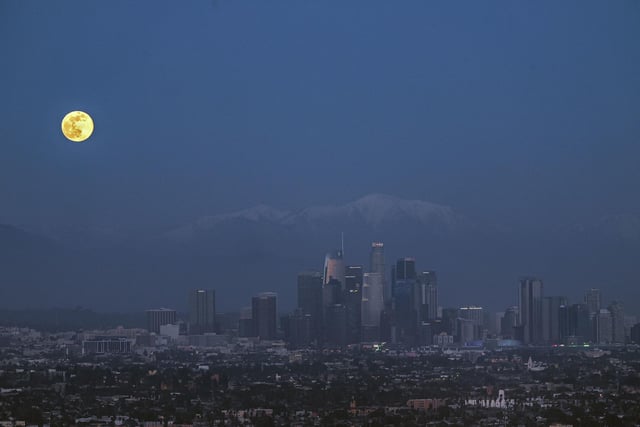 The new year's first moon rises over the Los Angeles skyline in the USA