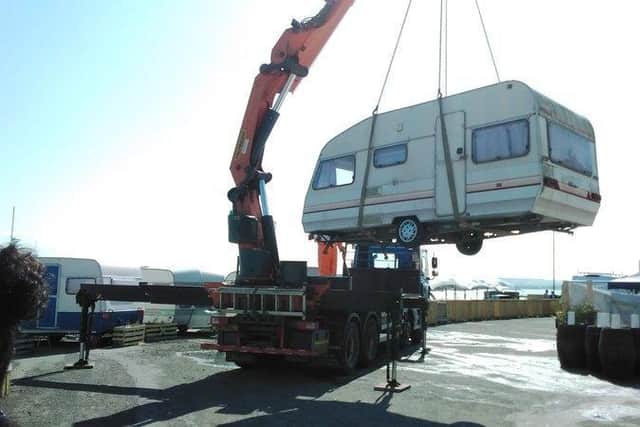 Two abandoned caravans have been craned out of the car park at King's Place