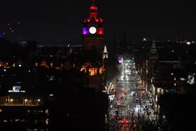 A near-deserted Princes Street in Edinburgh is pictured as the time passes midnight on New Year's Day