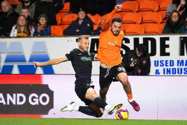 Ryan Porteous of Hibs tackles Dundee United forward Tony Watt during the Tannadice encounter