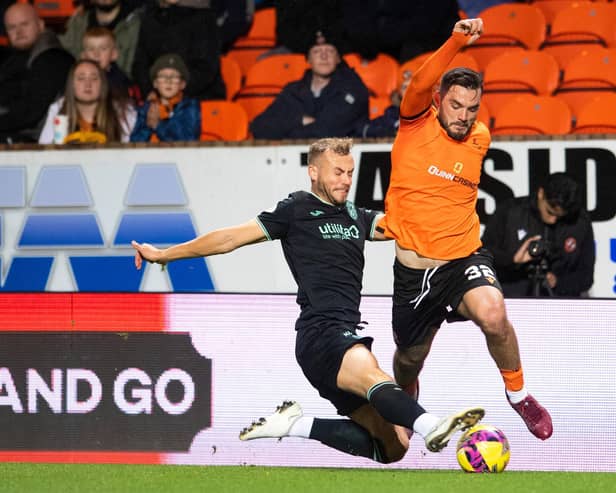 Ryan Porteous of Hibs tackles Dundee United forward Tony Watt during the Tannadice encounter
