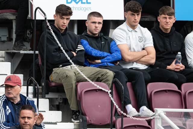 Former Hearts full-back Aaron Hickey, now at Brentford, watches on with Connor Smith, who is on loan at Hamilton, and Lewis Neilson