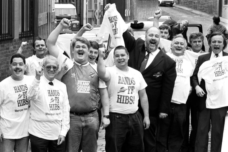 Fans wearing their Hands off Hibs! t-shirts celebrate the news that Hearts FC chairman Wallace Mercer has withdrawn his offer to buy Hibernian FC football team, July 1990,