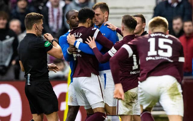 Referee Nick Walsh showed a red card to Hearts winger Josh Ginnelly after he clashed with Borna Barisic. Picture: SNS