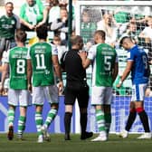 Hibs players make their feelings known to referee Willie Collum after he awards a penalty to Rangers in the first half of the 2-2 draw between the two teams