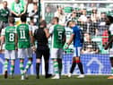 Hibs players make their feelings known to referee Willie Collum after he awards a penalty to Rangers in the first half of the 2-2 draw between the two teams