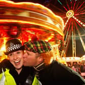 Police constable Lee Dingsdale receives a kiss from Aiden Cooper as revellers take to Princes Street to celebrate New Year on December 31, 2008.