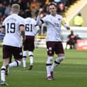 Hearts defender Alex Cochrane is told to get back on the pitch by captain Lawrence Shankland.