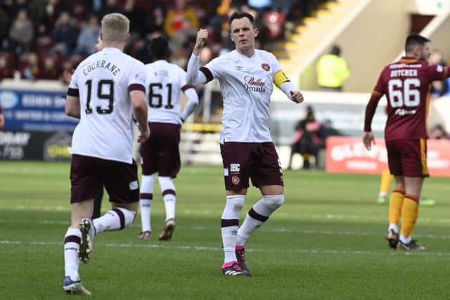 Hearts defender Alex Cochrane is told to get back on the pitch by captain Lawrence Shankland.