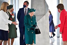 Queen Elizabeth is greeted by Nicola Sturgeon at the opening of the sixth session of the Scottish Parliament (Picture: Jeff J Mitchell/Getty Images)