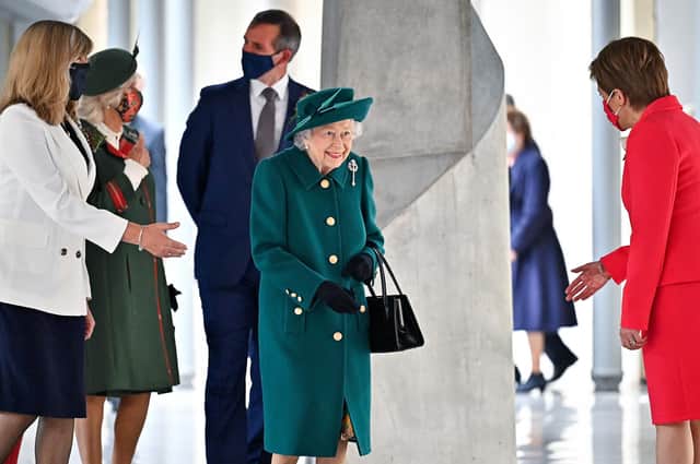 Queen Elizabeth is greeted by Nicola Sturgeon at the opening of the sixth session of the Scottish Parliament (Picture: Jeff J Mitchell/Getty Images)
