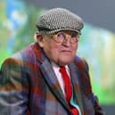 British painter David Hockney poses at the Orangerie museum in Paris, in 2021, in front of his painting "A year in Normandy"
