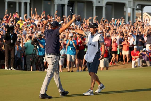 Phil Mickelson celebrates with brother and caddie Tim Mickelson on the 18th green. Picture: Patrick Smith/Getty Images.