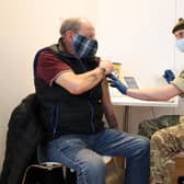 Derek Fraser from Edinburgh receives an injection of a coronavirus vaccine from military doctor Captain Robert Reid from 3 Medical Regiment who are assisting with the vaccination programme at the Royal Highland Showground near Edinburgh. Picture date: Thursday February 4, 2021.