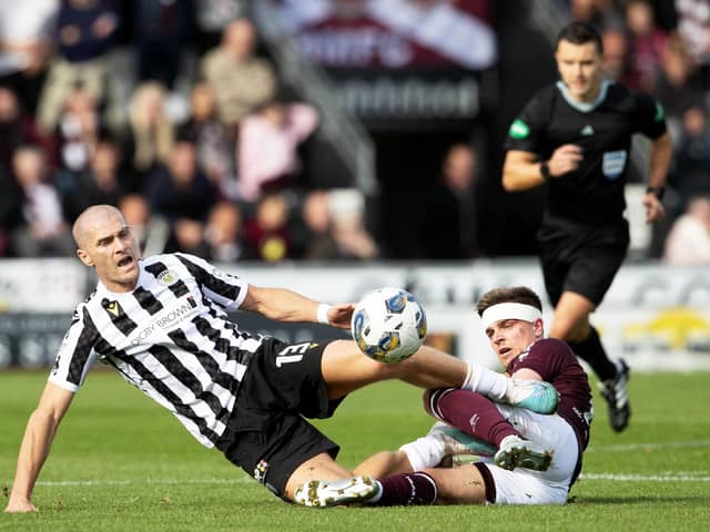 St Mirren's Alex Gogic and Hearts' Cammy Devlin challenge for the ball in Paisley. Pic: SNS