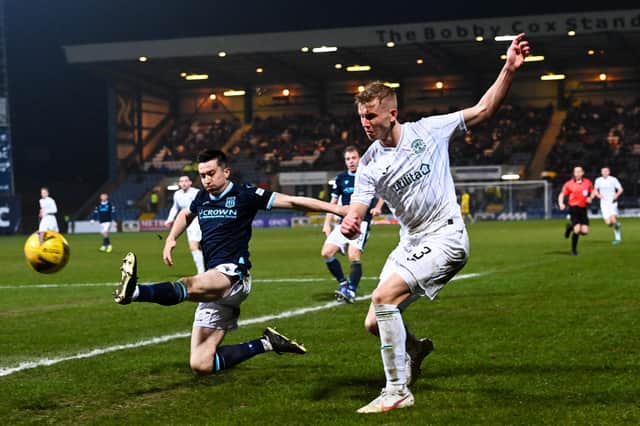 Dundee's Cammy Kerr attempts to block Josh Doig's cross during the goalless draw at Dens Park