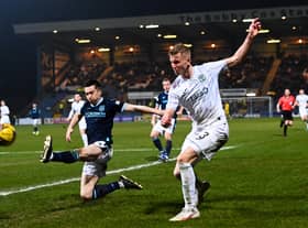 Dundee's Cammy Kerr attempts to block Josh Doig's cross during the goalless draw at Dens Park