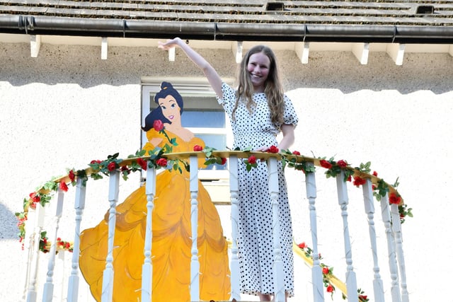 Olivia King, Maid of Honour, give a wave from the balcony of her arch