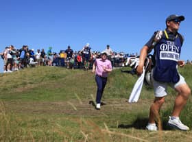 Bob MacIntyre runs to catch up with caddie Mike Thomson after teeing off at the third hole in the third round of the 149th Open at Royal St George’s. Picture: Andrew Redington/Getty Images.