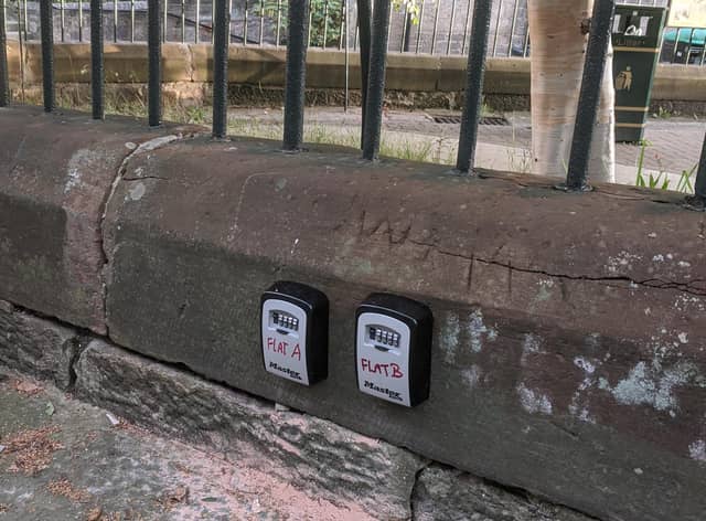 The two lock boxes on the wall surrounding the play area in Dean Village