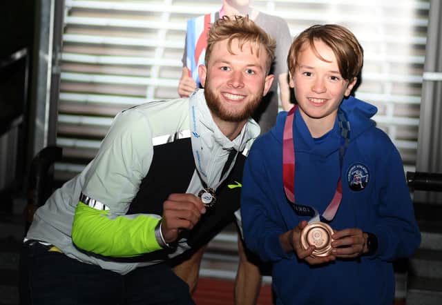 Josh swapping medals with youngster Josh Daunt, who was presented with a bronze in the under 13's Scottish Hill Running Champs at Caddemuir Rollercoaster, Peebles on August 14. (Picture credit: Gary Leek)