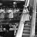 Queen Elizabeth II officially opened the Waverley Market shopping centre in Princes Street Edinburgh, July 1985. The Queen comes down the escalator.