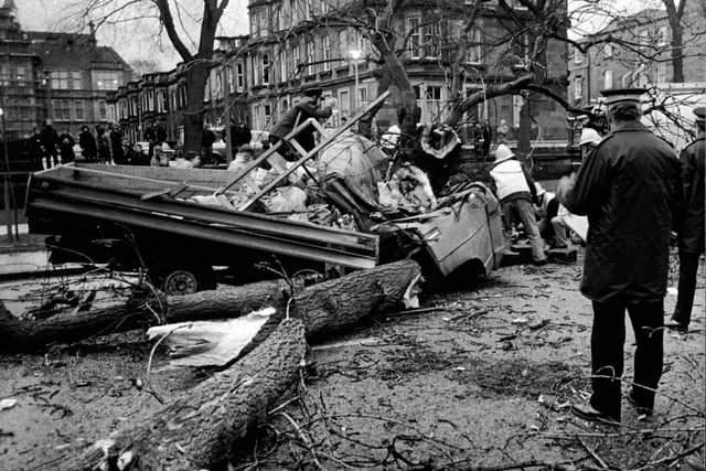 Firemen in the Meadows in Edinburgh in December 1982, where a 50-ft tree was blown down and fell on a truck, killing the driver Stanislaw Jakubanes of Largs. The passenger, Danuta Maj was trapped in the cab and broke both legs.