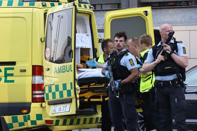 An ambulance and armed police outside the Field's shopping center, in Orestad, Copenhagen, Denmark, Sunday, July 3, 2022, after reports of shots fired. Danish police say several people have been shot at a Copenhagen shopping mall. Copenhagen police said that one person has been arrested in connection with the shooting at the FieldÕs shopping mall on Sunday. Police tweeted that Òseveral people have been hitÓ but gave no other details. (Olafur Steinar Gestsson /Ritzau Scanpix via AP)