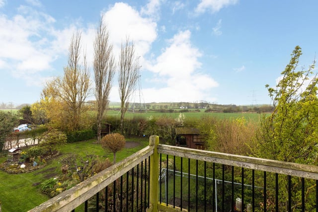 The balcony of the workshop offers great views of the surrounding area. As well as the rear garden, there is an enclosed, well maintained front garden with driveways either side which both give gated access to the larger rear garden. To the side of the property is an external store which houses the boiler with the Oil tank located behind.