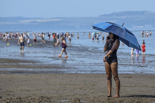 Beach-goers were well prepared for the heat on Monday, with many bringing parasols, umbrellas and cover ups.