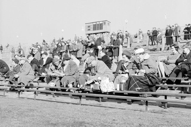 The rugby jamboree at Murrayfield in 1963. Spectators enjoy a snack for lunch on the terracing.