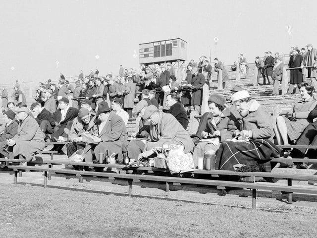 The rugby jamboree at Murrayfield in 1963. Spectators enjoy a snack for lunch on the terracing.