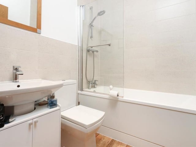 Before we take a look at the bedrooms, here is the family bathroom. It comes complete with bath and overhead shower, low-flush WC, wash hand basin and cupboard unit.