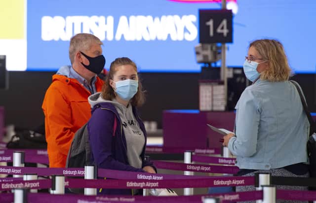 People arriving in masks at Edinburgh Airport.
