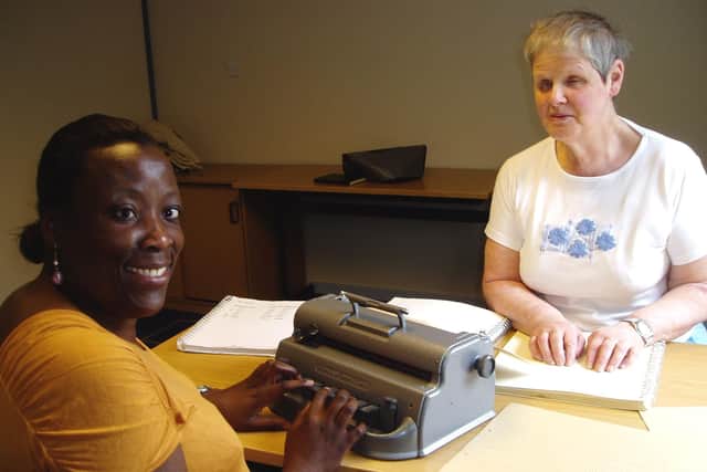 Sue Marshall, right, with one of many braille learners she has taught over the years.