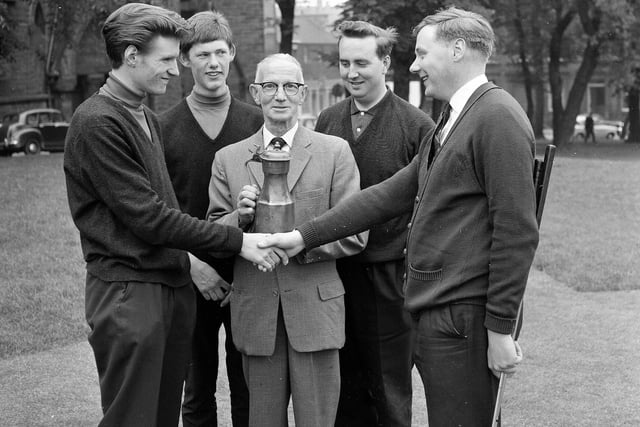 Councillor James Ross presents a trophy to the winner of the Tappit Hemn Tournament on the Bruntsfield short hole course in July 1965.