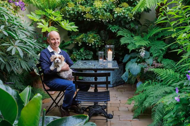 The winner of Gardeners' World Magazine's garden of the year 2023 was Edinburgh resident Clive Johnson-Cooper. Here we see Clive with his dog Popsey enjoying a peaceful time in the garden