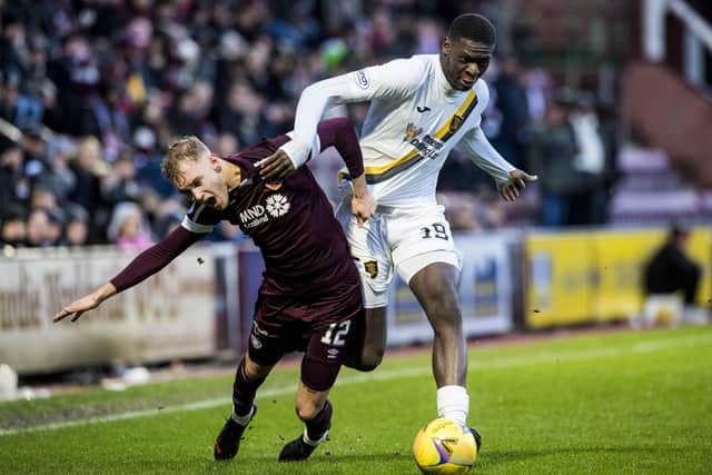 Nathaniel Atkinson battles for possession with Livingston's Joel Nouble