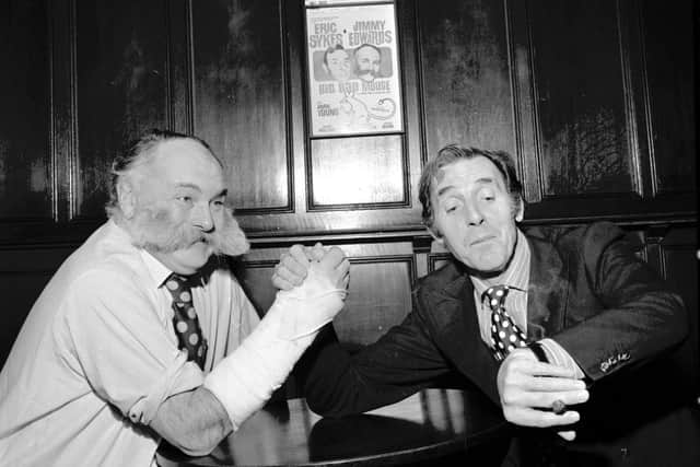 Actors and comedians Jimmy Edwards and Eric Sykes demonstrate arm-wrestling (notice Edwards' is at a disadvantage, his arm in plaster) at the King's Theatre, Edinburgh, before Big Bad Mouse in February 1973.