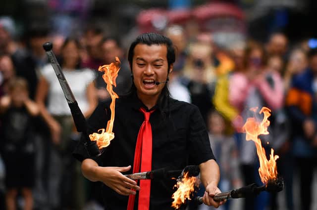 A Festival Fringe entertainer juggles on the Royal Mile in 2019 (Picture: Jeff J Mitchell/Getty Images)
