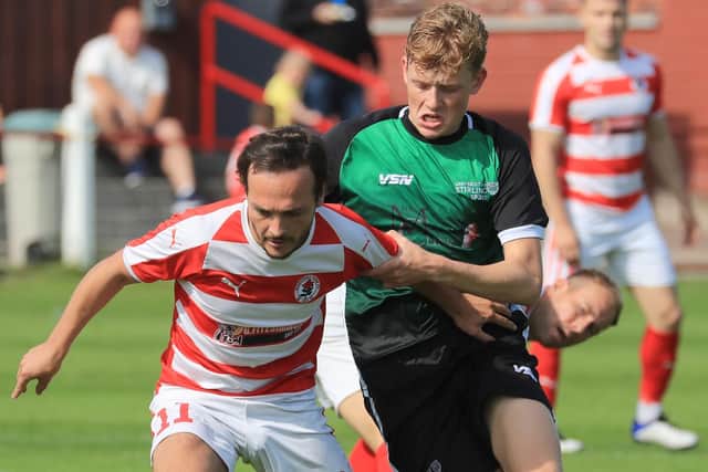 Ross Gray holds off an opponent during Bonnyrigg Rose's win over University of Stirling (pic: Joe Gilhooley)
