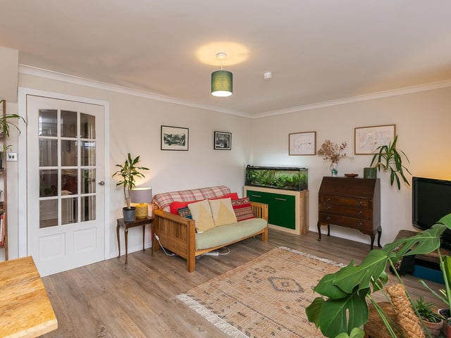 The lounge and dining room, featuring a patio door to the garden and a central pendant light fitting.