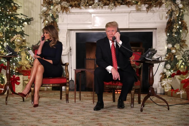 President Donald Trump and first lady Melania Trump talk to children as they track Santa Claus's movements with the North American Aerospace Defense Command (NORAD) Santa Tracker on Christmas Eve at the White House.  This is what the President said to one young caller "“Are you still a believer in Santa? Because at 7, it’s marginal, right?”"