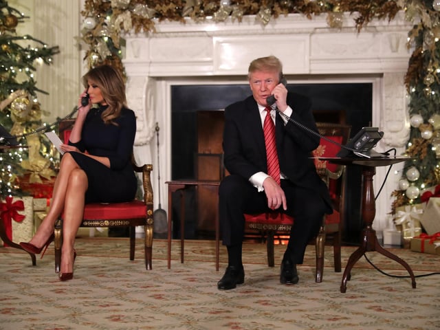 President Donald Trump and first lady Melania Trump talk to children as they track Santa Claus's movements with the North American Aerospace Defense Command (NORAD) Santa Tracker on Christmas Eve at the White House. This is what the President said to one young caller "“Are you still a believer in Santa? Because at 7, it’s marginal, right?”"