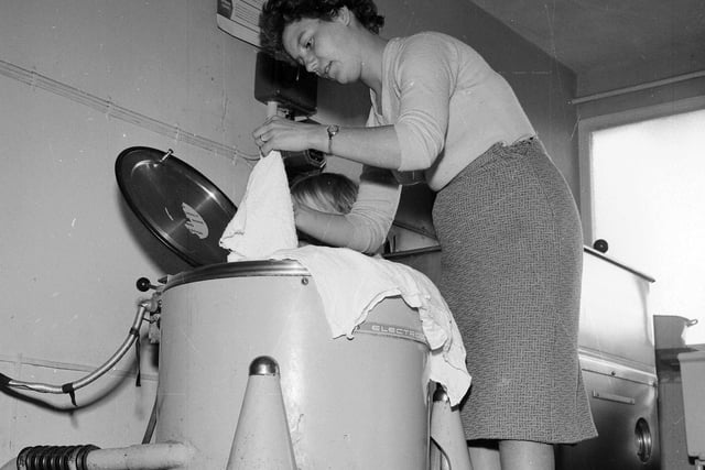 In October 1963 residents started a petition for drying space in Muirhouse. One of the campaigners, Irene Fleeting, is pictured washing nappies.