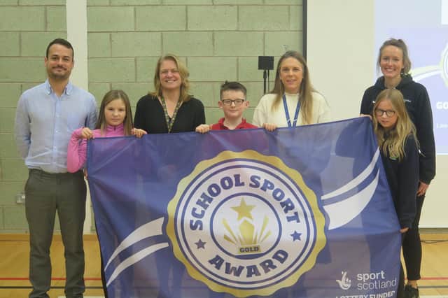Pictured (l-r) are: Jennifer Allison is pictured with staff, pupils and and Michelle Bone from sportscotland.