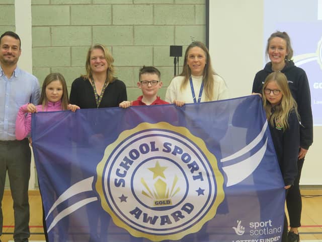Pictured (l-r) are: Jennifer Allison is pictured with staff, pupils and and Michelle Bone from sportscotland.